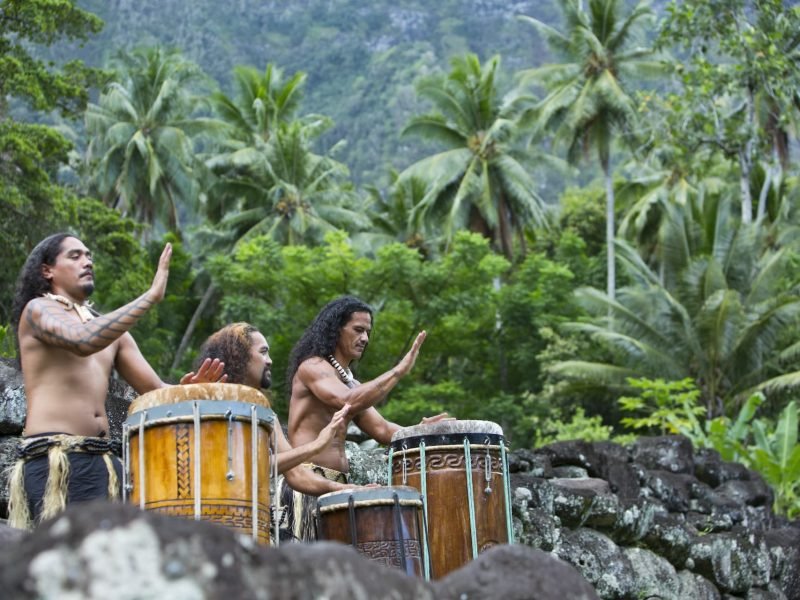 trois musiciens marquisiens jouant du pahu dans la forêt de Hiva Oa