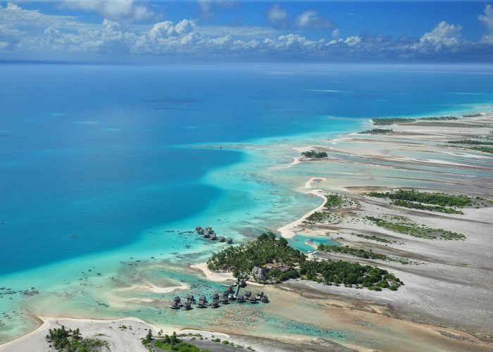 subtiles-tahiti-tikehau-hôtel-le-tikehau-by-pearl-resorts-1©le-tikehau-by-pearl-resorts Hôtel Le Tikehau by Pearl Resorts 4*- vue aérienne sur l'hôtel, les bungalow sur pilotis le lagon et les motus de Tikehau.